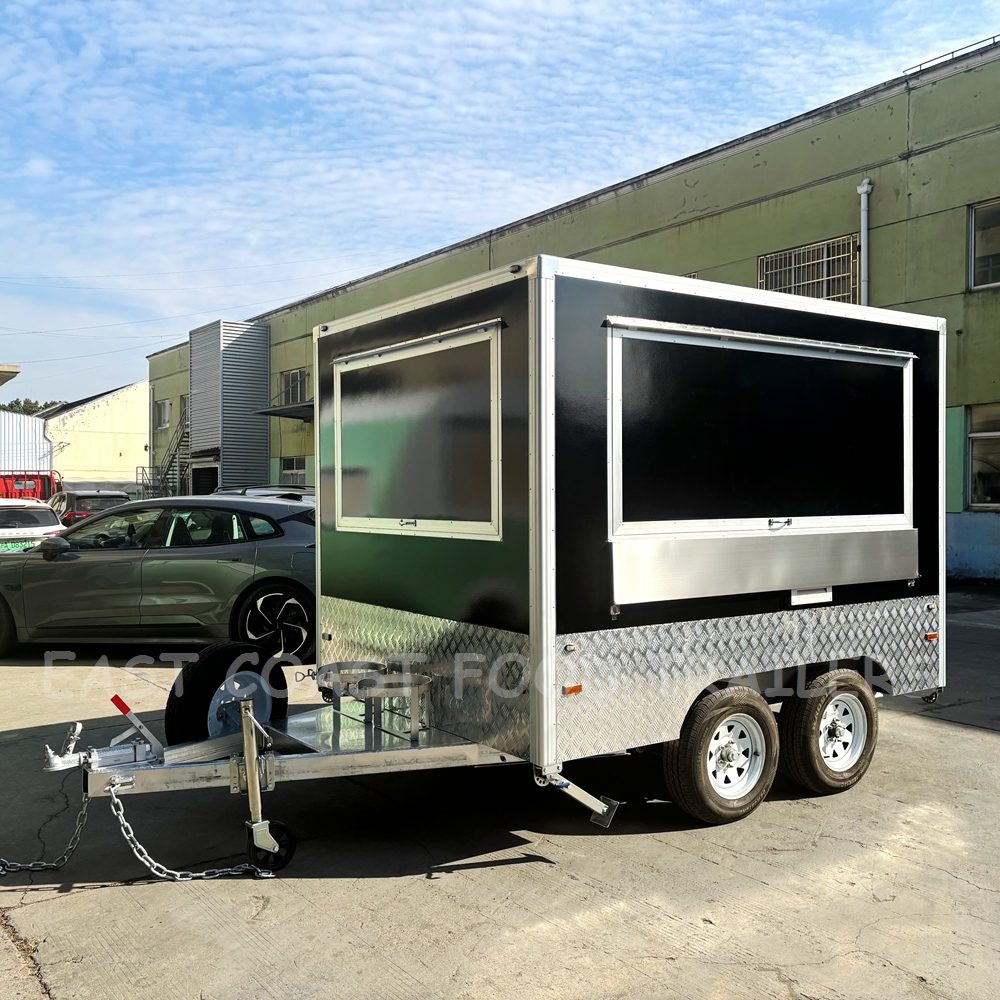 Mid-size black and white food trailer with wide serving window