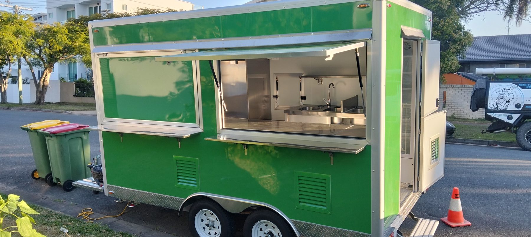Green food trailer with open serving windows