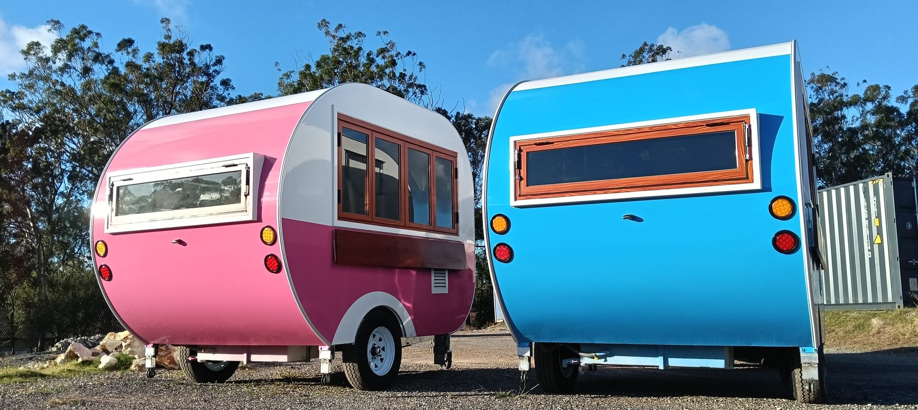 Pink and blue teardrop trailers side by side
